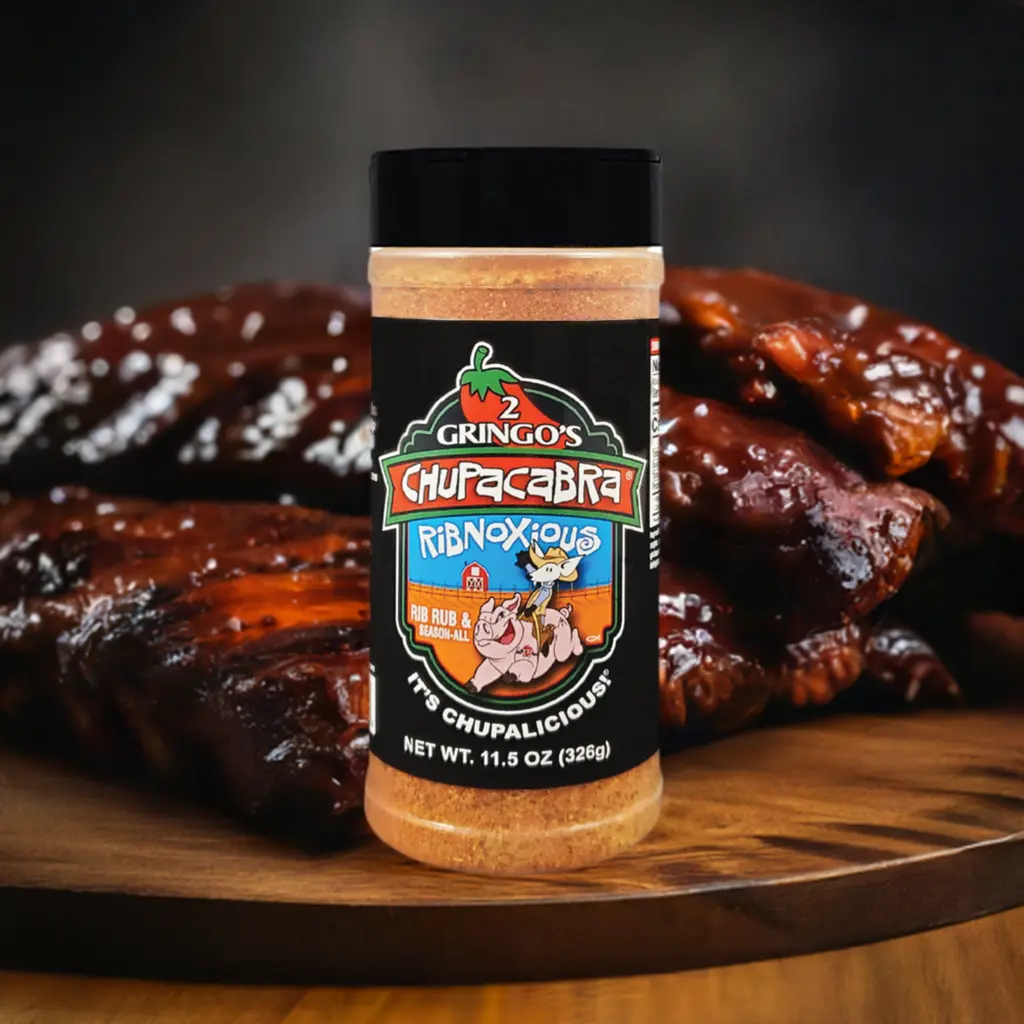 12 oz bottle of ribnoxious with smoked ribs in the background