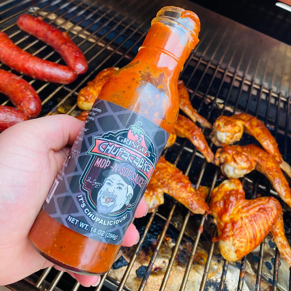 bottle of mop-n-sop with grilled chicken and sausage