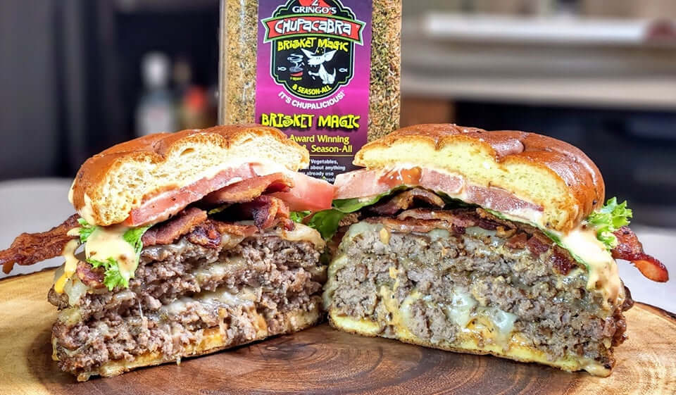 25 oz brisket magic with a cut open bacon cheeseburger